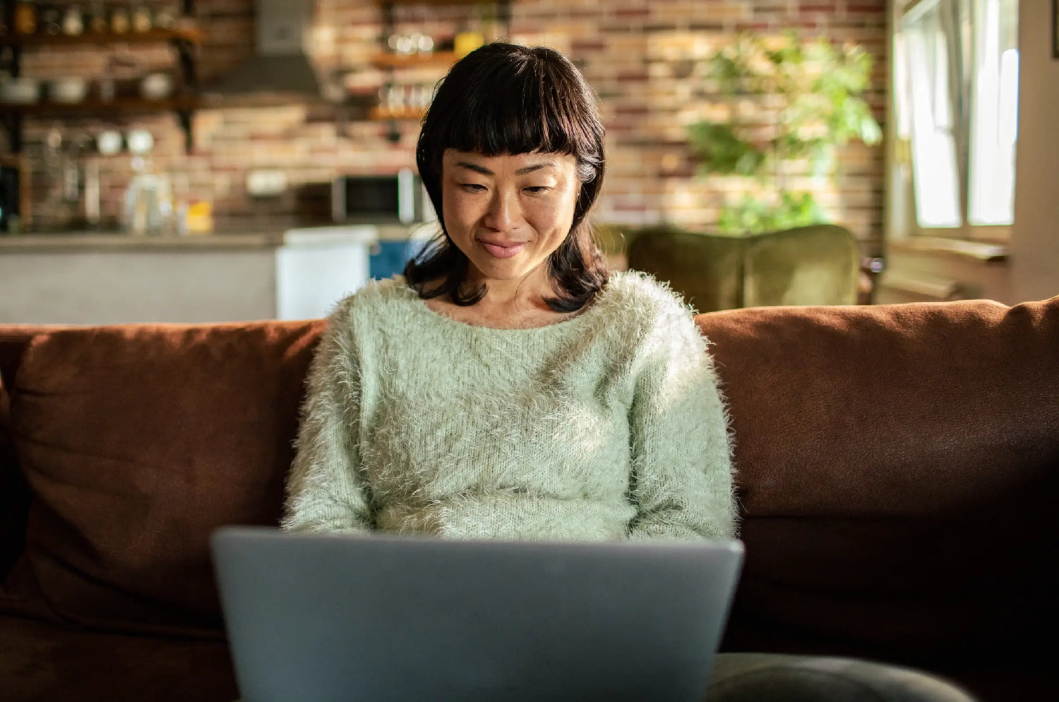 woman on a laptop sitting on the couch